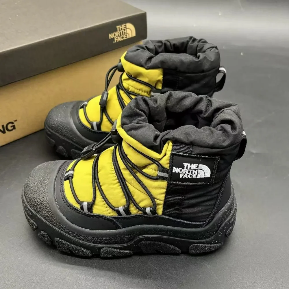 The North Face Yellow and black insulated snow boots with drawstring collar