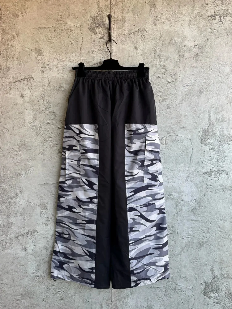 black waistband wide-leg pants with gray black camo side panels and cargo pockets