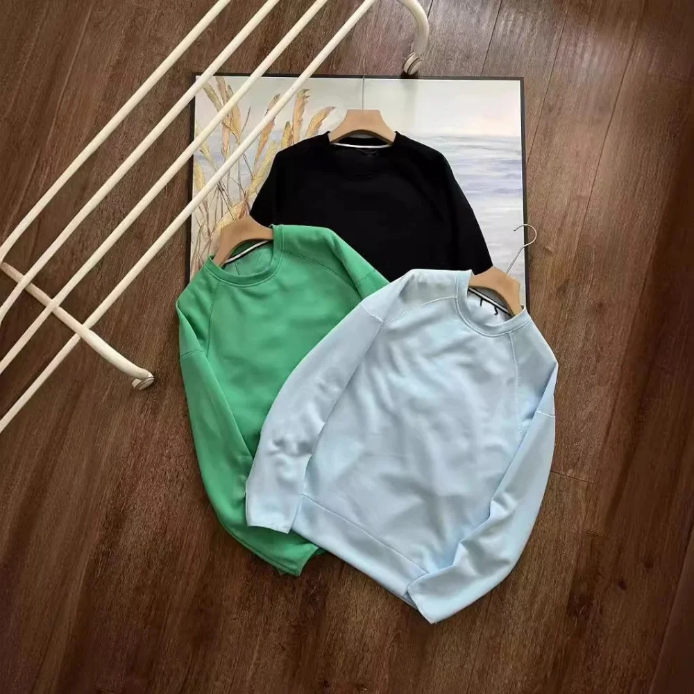 Solid color crewneck sweatshirt with raglan sleeves and matching joggers featuring side zippered pockets