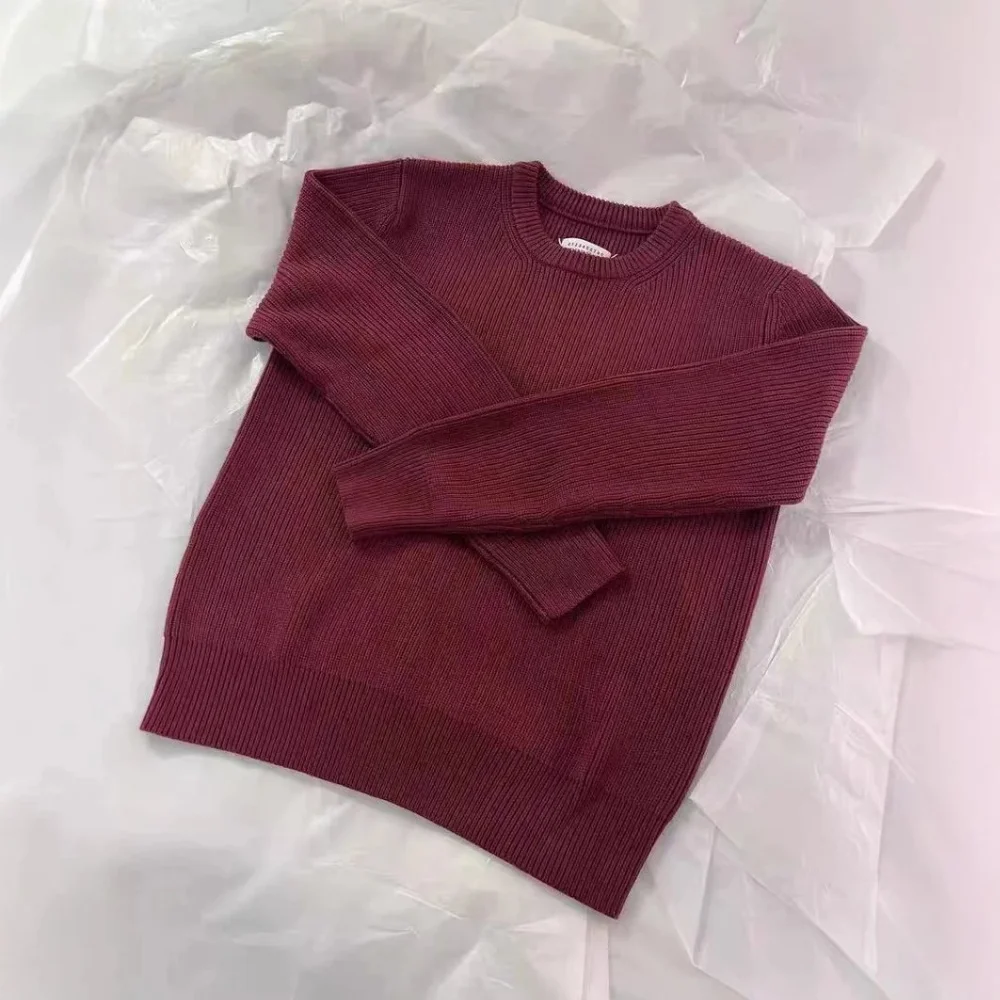 black ribbed knit sweater with white contrast stitching