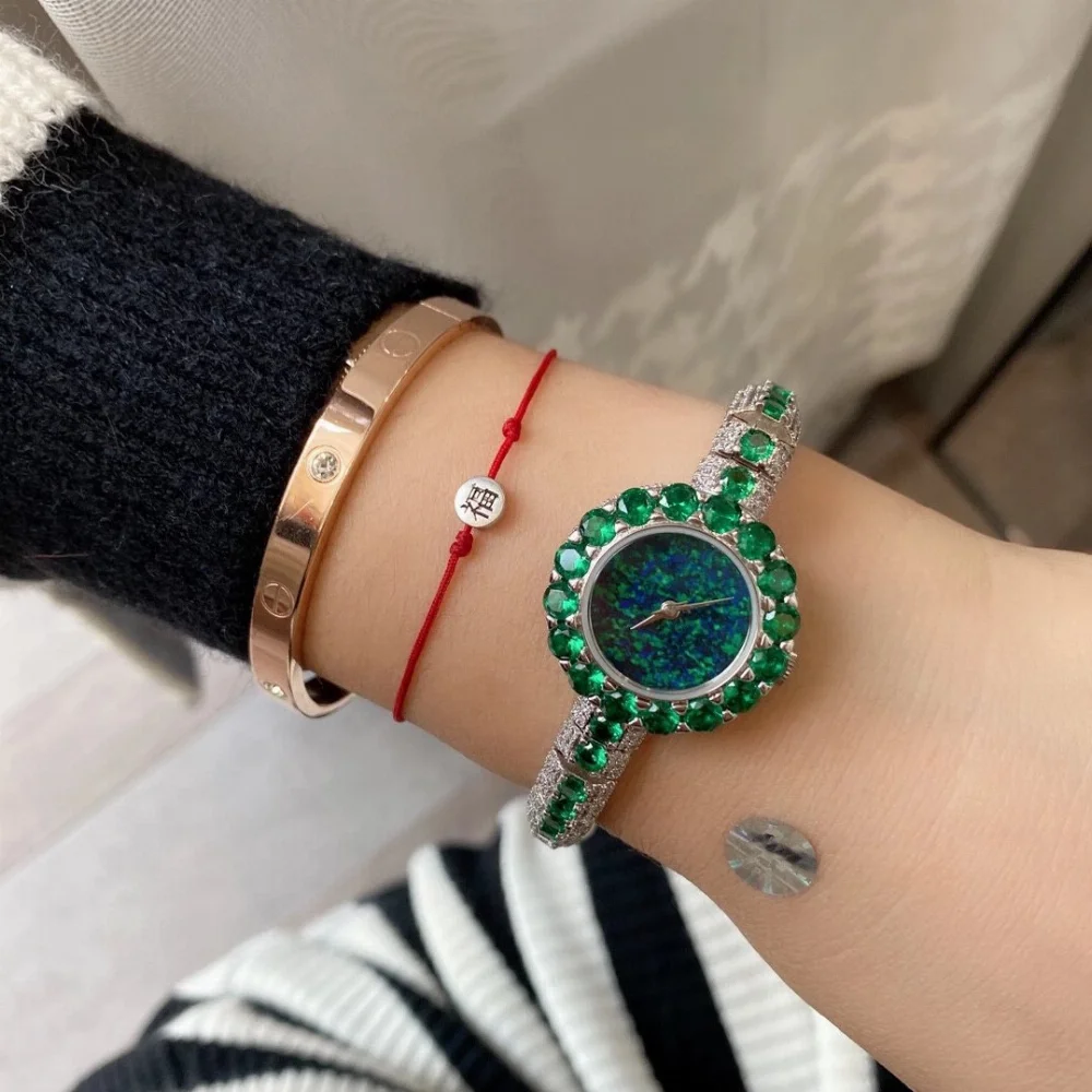 Rose gold tone bracelet watch fully paved with clear green or pink crystals and opal-like dial