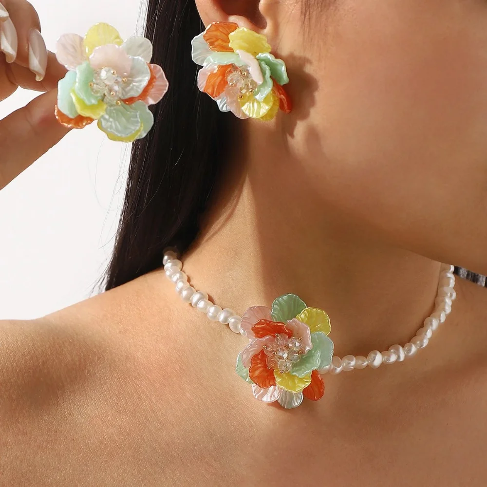 Cream floral resin earrings with pearl cluster center