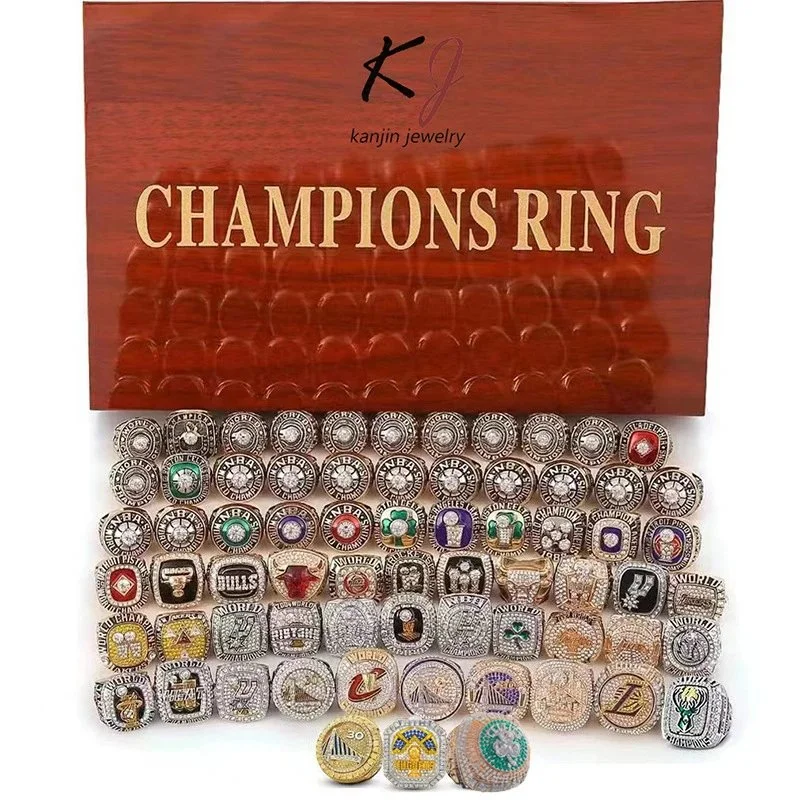 Gold and silver tone championship rings with team logos enamel stones in wooden display box