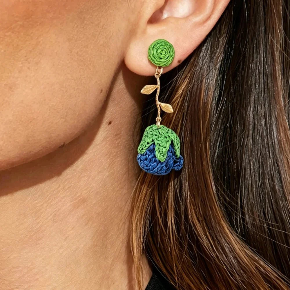 handwoven raffia flower earrings with green stem and leaves