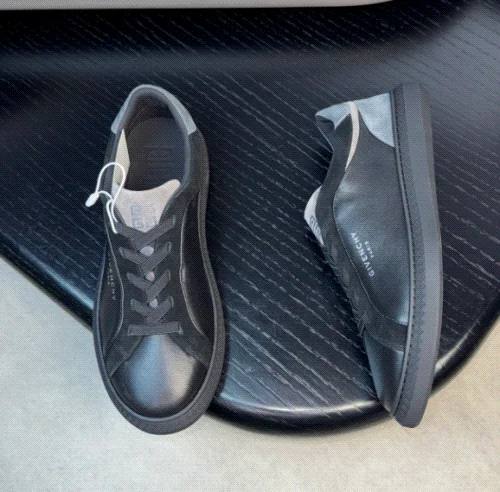 Givenchy Black leather low-top sneakers with grey paneling and lace-up closure