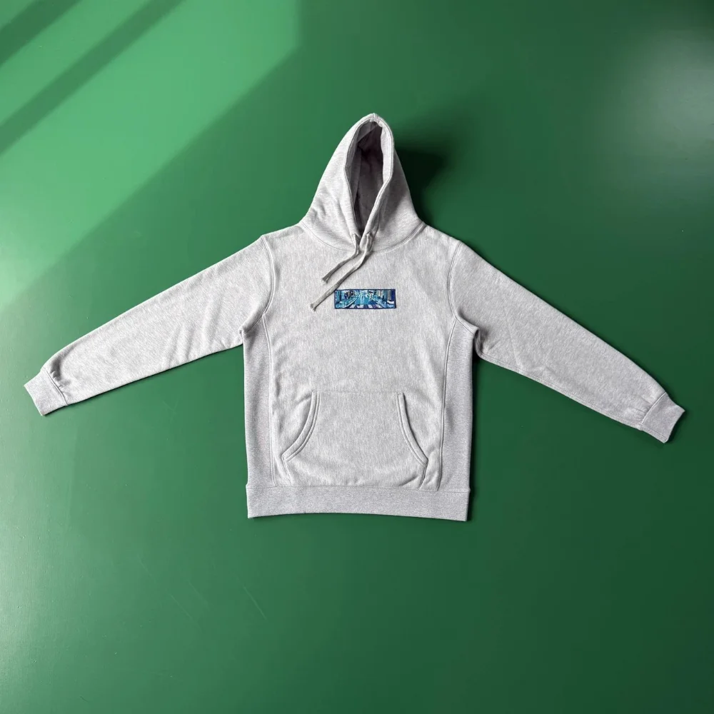 Heather grey pullover hoodie with blue rectangular graphic patch on chest