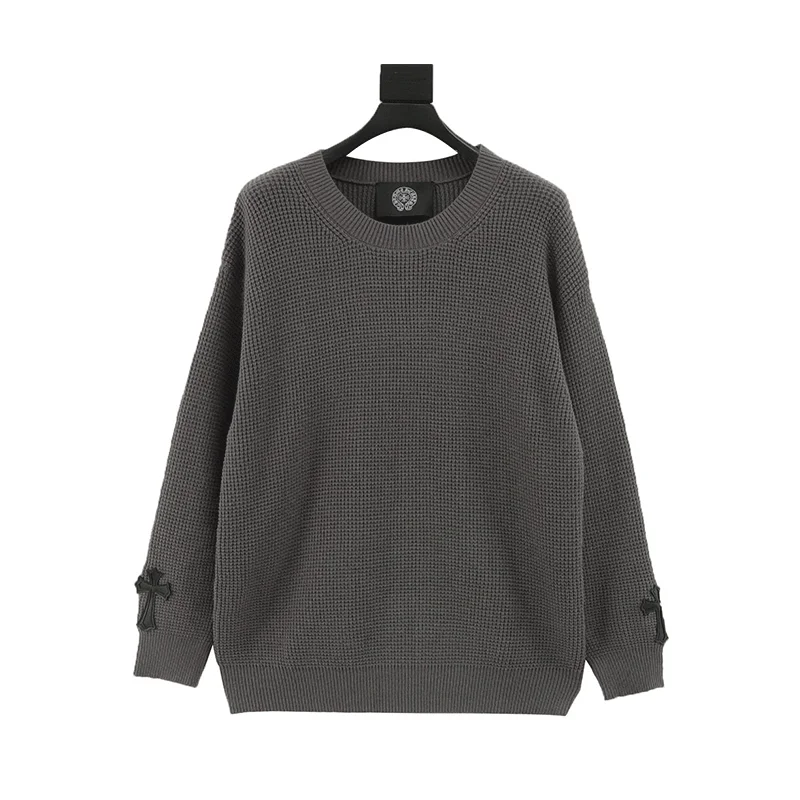 Waffle knit long-sleeve sweater with black cross patches on cuffs