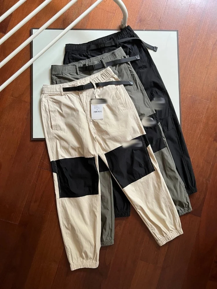 Black grey beige cargo jogger pants with black contrast knee panels and elastic cuffs