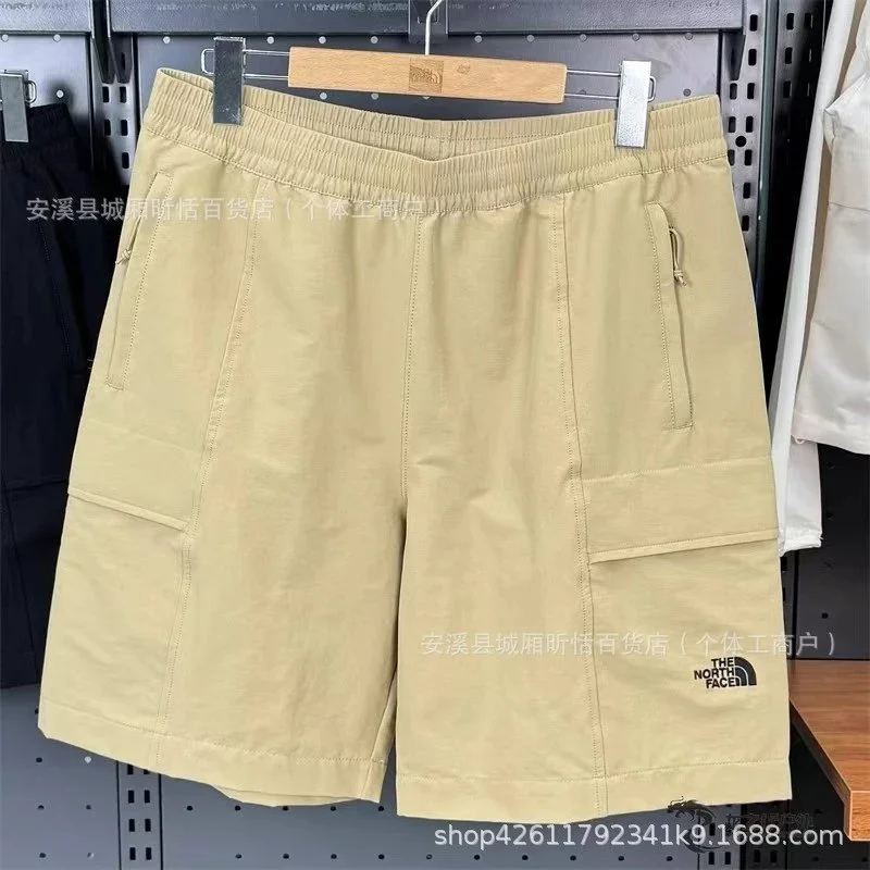 The North Face khaki cargo-style shorts with side pockets and elastic waistband