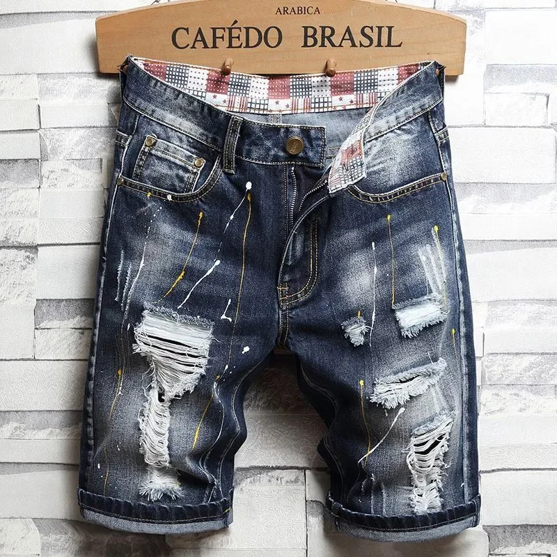 Light wash distressed denim shorts with patchwork lining and ripped details