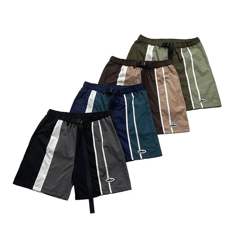 Navy and teal panelled shorts with white side stripes and black waist strap