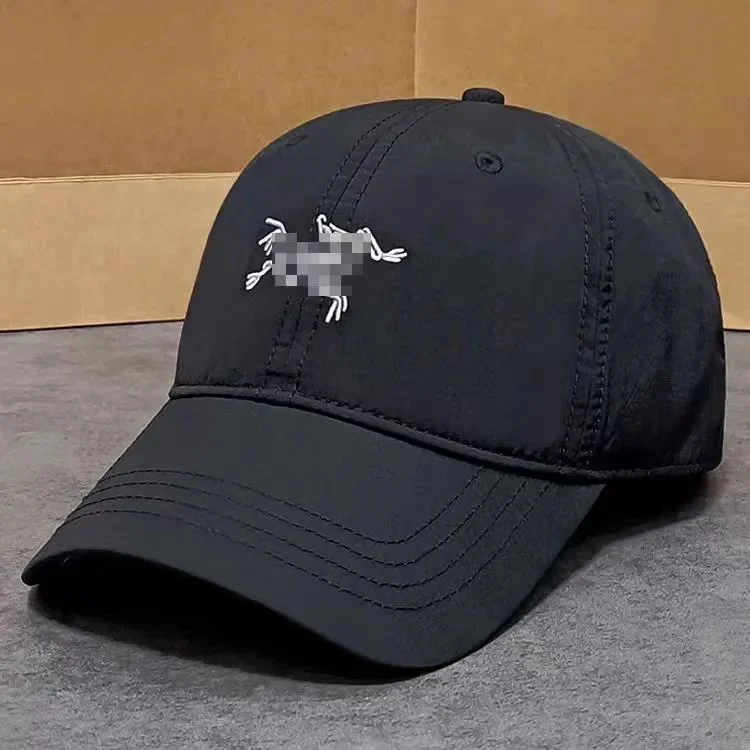 White navy beige nylon baseball cap with circular black logo patch