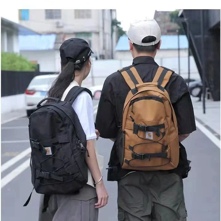 Carhartt Brown and black nylon backpacks with webbing straps and front buckle