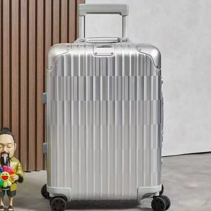 silver aluminum hardshell rolling carry-on luggage with vertical ribbed texture