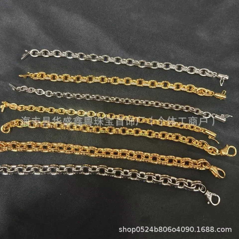 Chunky silver-tone and gold-tone chain link bracelet with green rhinestones