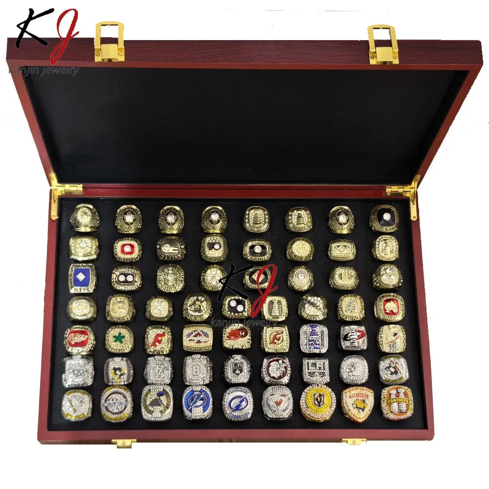 Gold and silver tone NHL team logo championship rings in display case
